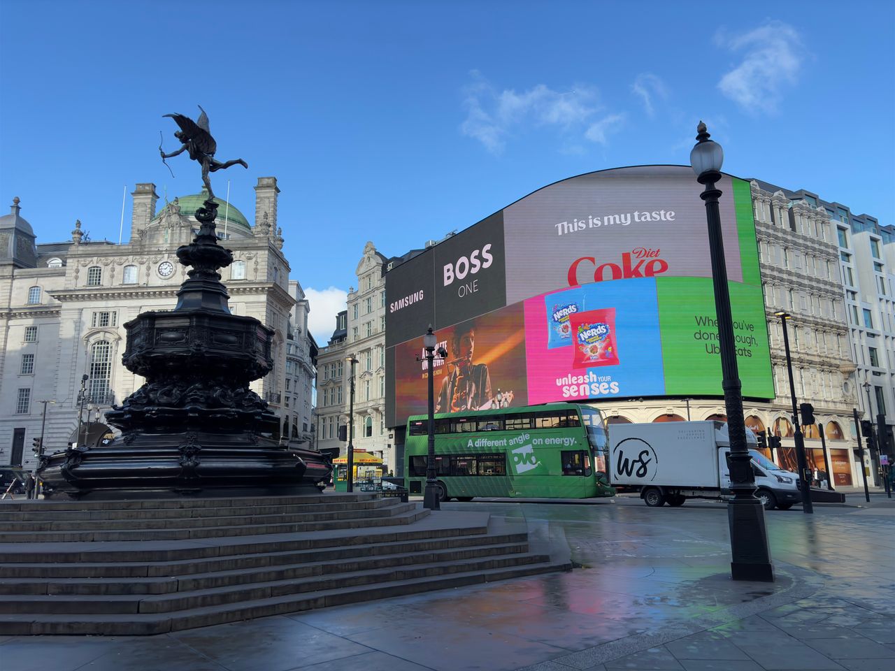 Oferty Piccadilly Circus in London featuring the iconic Shaftesbury Memorial Fountain and digital billboards on a quiet day.